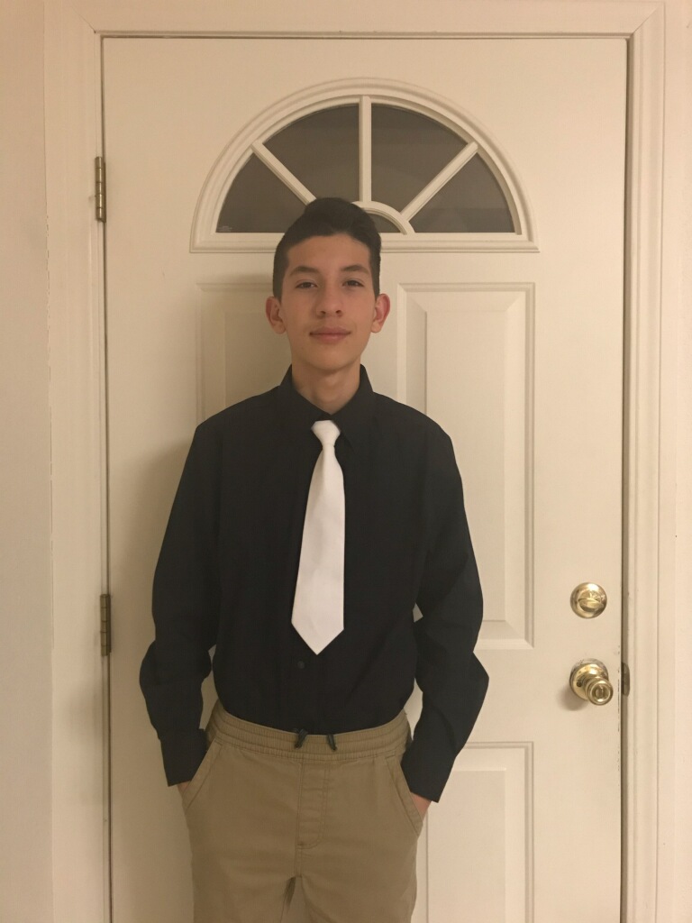 a student in black shirt and white tie