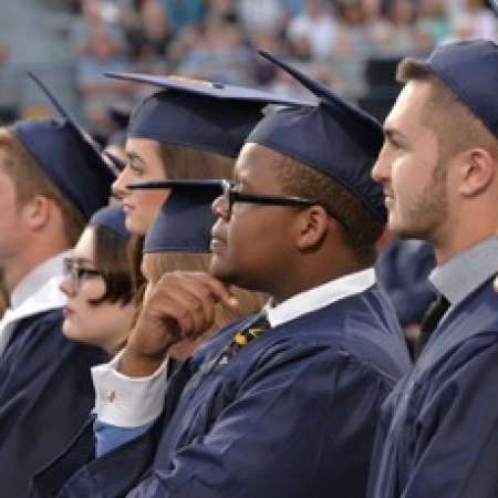 Chris H. paying attention during the HS Graduation.