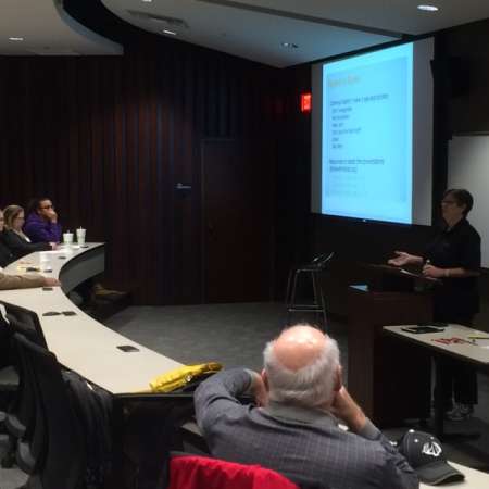 Group listens to guest speaker presentation.