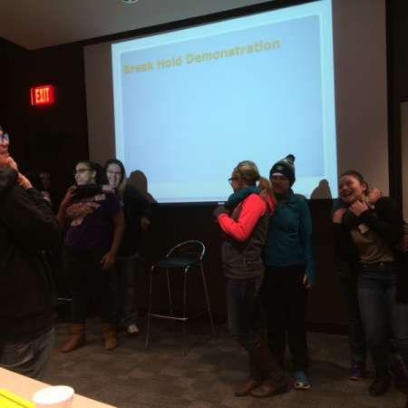 Students and parents practice self defense moves.