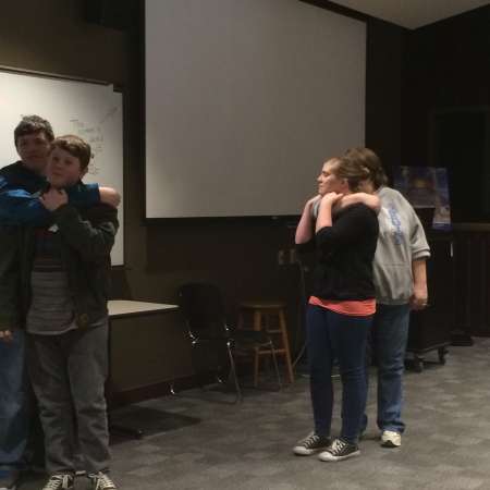 Students and parents practice self defense moves.