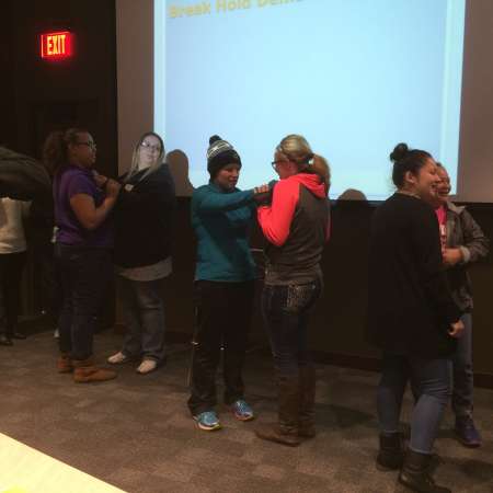 Students and parents practice self defense moves.