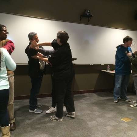 Students and parents practice self defense moves.