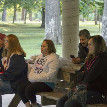 Observers wait to see runners come back into the park.