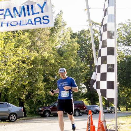 3rd Place Male crosses the finish line.