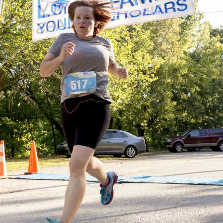 First place female crosses the finish line.