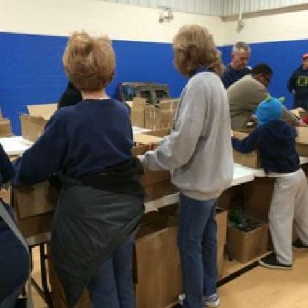 Karen L. works to pack boxes.