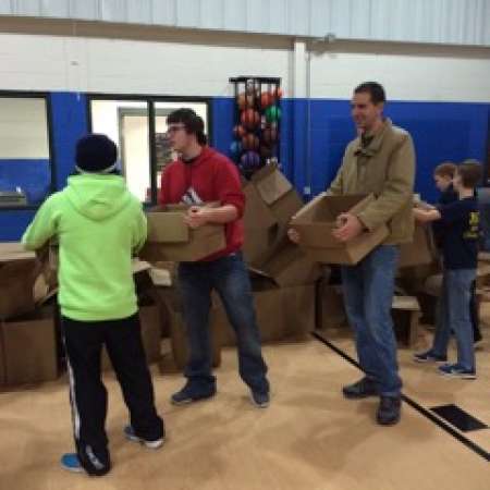 Mentors and students work together to pack boxes.