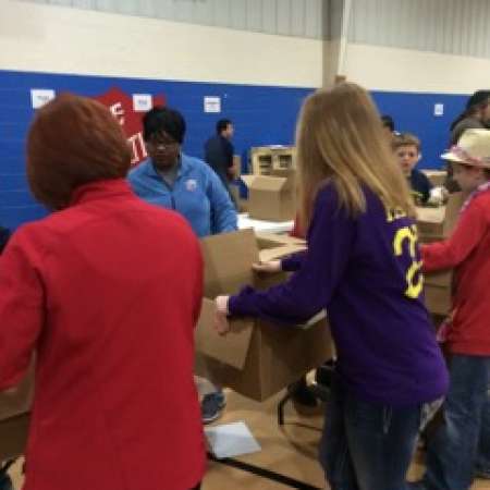 Group works to pack boxes.