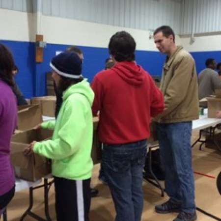 Mentor Stephen and Mentee Jacob work together to pack boxes.