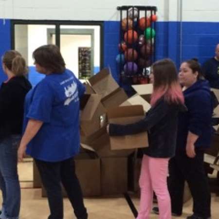 Parents and students work together at volunteer event.