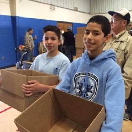 Students work to pack boxes for the Salvation Army.