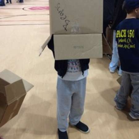 Students have fun while packing boxes for the Salvation Army.
