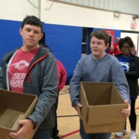 Students Landry E. and Matthew M. work to pack boxes.