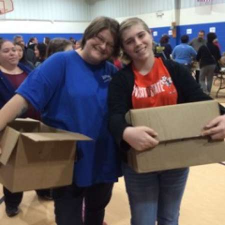 Student Hope B. and parent Kathy Y. work at the Salvation Army project.