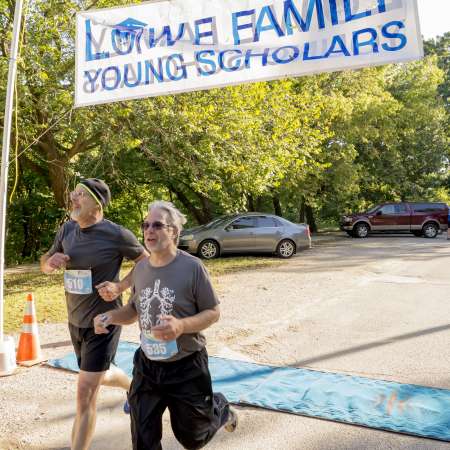 Runners cross the finish line.