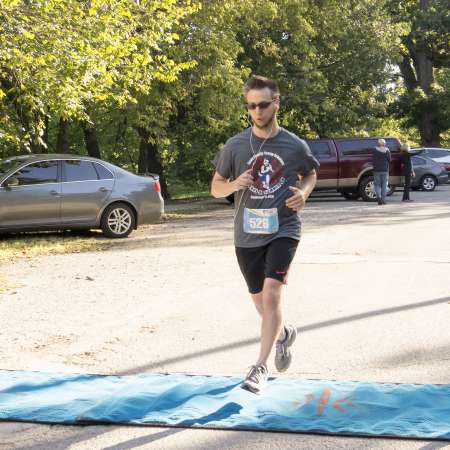 Mentor Paul P. crosses the finish line.