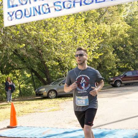 Mentor Paul P. crosses the finish line.