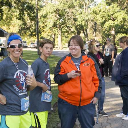 People wait for the remaining runners to cross the finish line.