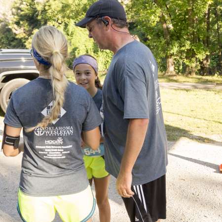 Family waits for remaining runners to cross the line.