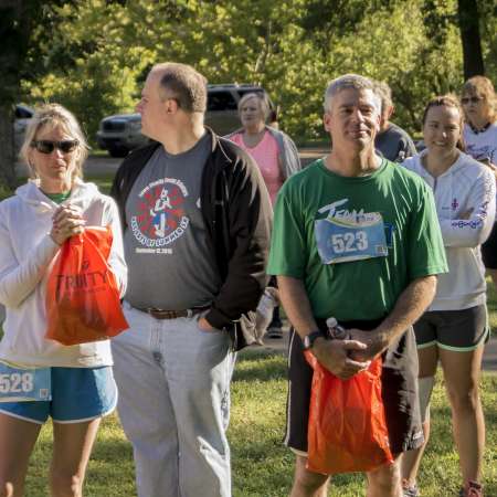 Runners wait through announcements.