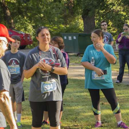 The runners listen to the ending announcements.