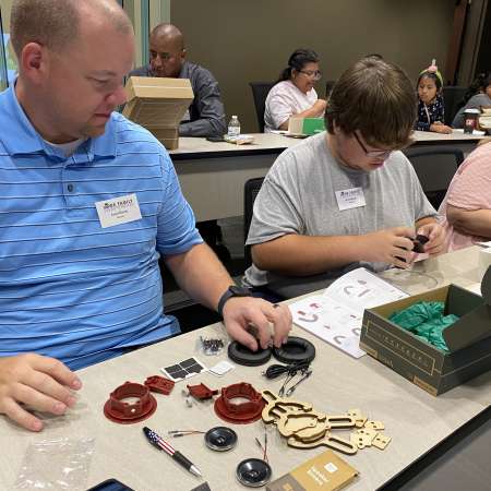 Student and Mentor putting together a robotics kit