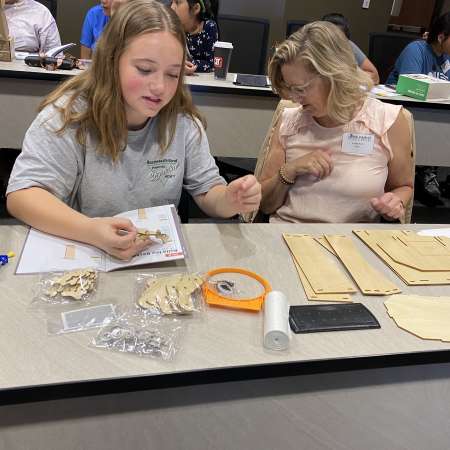 Student and Mentor putting together their robotics kit