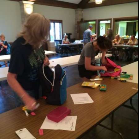 Families check the backpacks for accuracy.