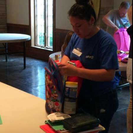 Volunteer checks backpack for accuracy.