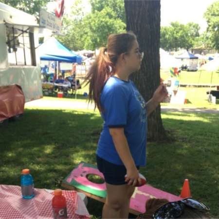 Samantha volunteers at SunFest booth.