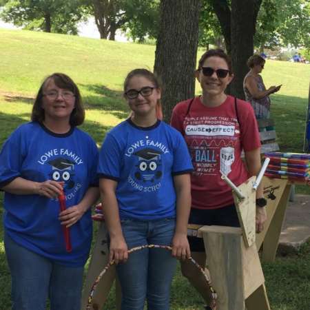 Emma volunteering with parent and mentor.