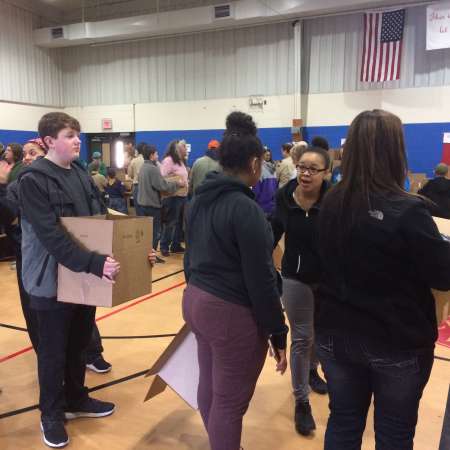 Students and parents wait to finish their boxes.