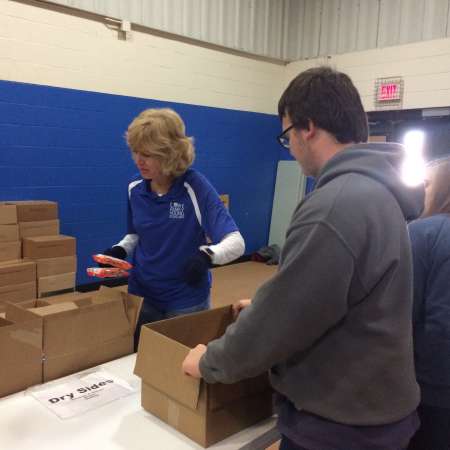 Students and parents wait to finish their boxes.