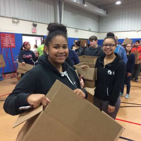 Volunteers work on packing their boxes.