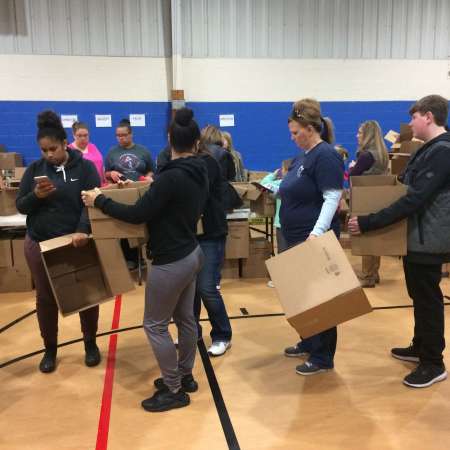 Volunteers work on packing their boxes.