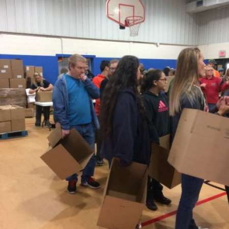 Volunteers waiting to pack their boxes.