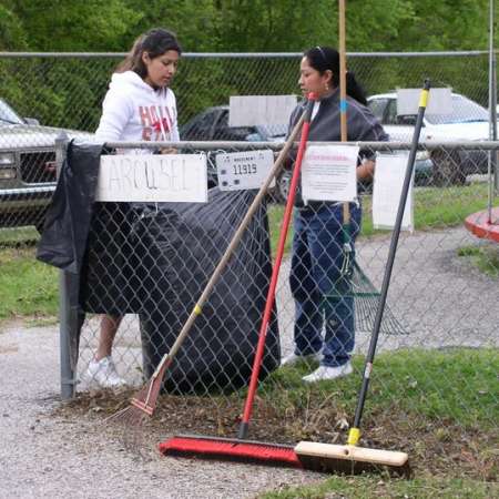 Volunteers clean up Kiddie Park to prepare it for opening weekend.