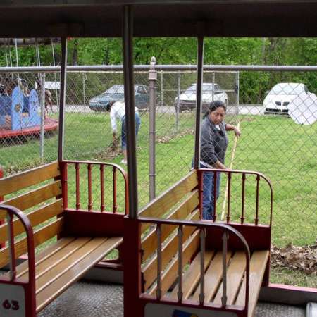 Volunteers clean up Kiddie Park to prepare it for opening weekend.