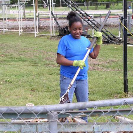 Volunteers clean up Kiddie Park to prepare it for opening weekend.