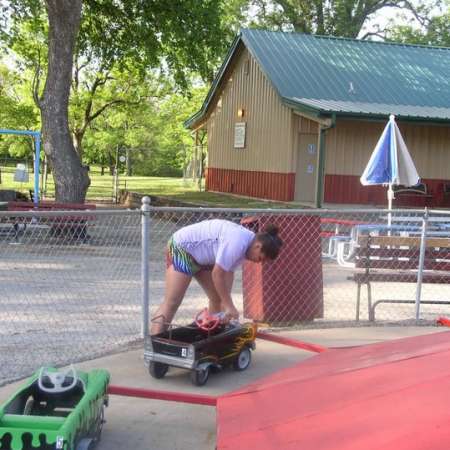 Volunteers clean up Kiddie Park to prepare it for opening weekend.