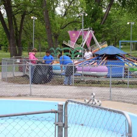 Volunteers clean up Kiddie Park to prepare it for opening weekend.