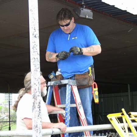 Volunteers clean up Kiddie Park to prepare it for opening weekend.