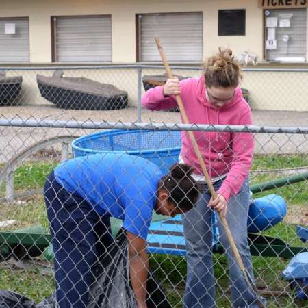 Volunteers clean up Kiddie Park to prepare it for opening weekend.