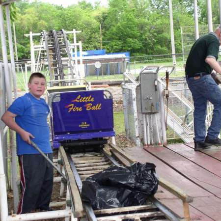 Volunteers clean up Kiddie Park to prepare it for opening weekend.