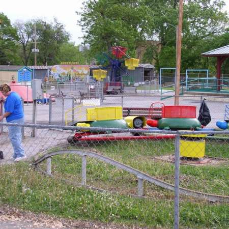 Volunteers clean up Kiddie Park to prepare it for opening weekend.