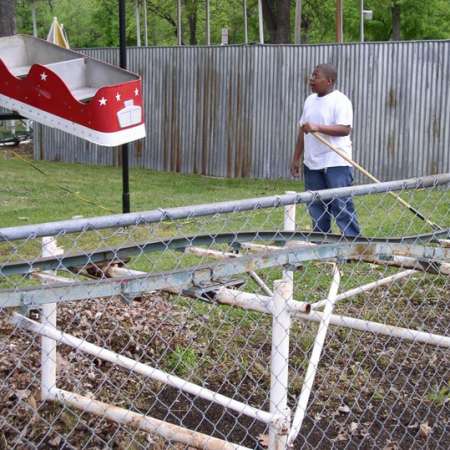 Volunteers clean up Kiddie Park to prepare it for opening weekend.