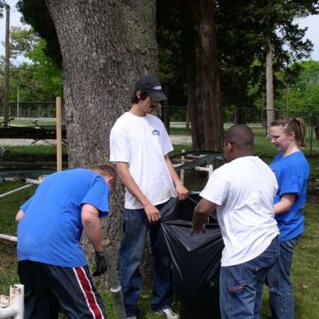 Volunteers clean up Kiddie Park to prepare it for opening weekend.