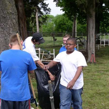 Volunteers clean up Kiddie Park to prepare it for opening weekend.