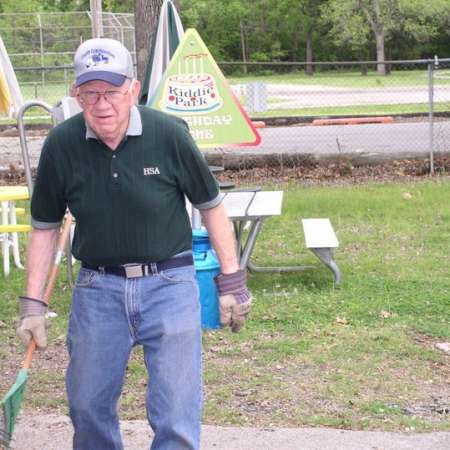 Volunteers clean up Kiddie Park to prepare it for opening weekend.